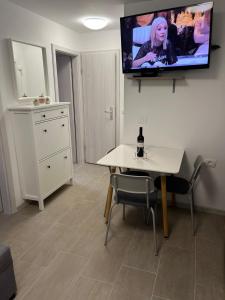 a living room with a table and a tv on the wall at Lexi 2 in Koper