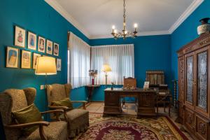 a blue room with a desk and chairs at Hotel Hontoria in Hontoria