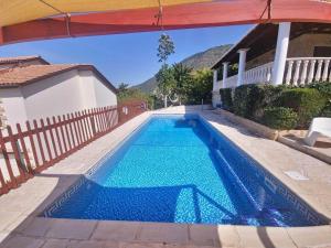 a swimming pool in a house with a blue pool at Pomos Harbourbiew Villa in Pomos