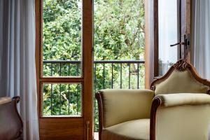 a room with two chairs and an open door at Hotel Hontoria in Hontoria