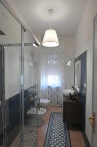 a bathroom with a shower and a toilet and a sink at Vista Mare casa vacanze in Torre Annunziata