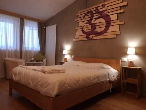 a bedroom with a bed with a sign on the wall at B&B EcoAntico casa in paglia in Maiolo