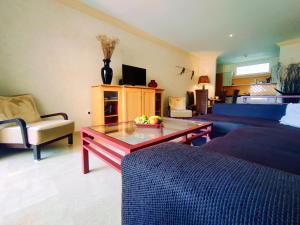 a living room with a couch and a coffee table at El Nautico Suites, Golf del Sur in San Miguel de Abona