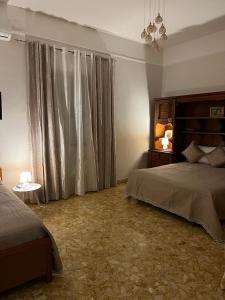a bedroom with a bed and a window with curtains at CASADOMA Oplonti Pompei in Torre Annunziata
