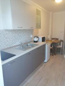 a kitchen with a sink and a counter top at Apartman Put 2 in Baška