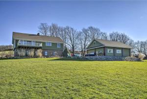 a house with a large yard with a grass field at Hilltop Retreat & Spa in Tully