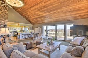 a living room with a couch and a tv and a table at Hilltop Retreat & Spa in Tully