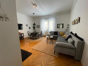 a living room with a couch and a table at Boennium Apartments Green Oasis in Ljubljana
