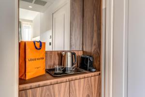 a kitchen with a coffee maker and a toaster at Sospeso Boutique Hotel in Milan