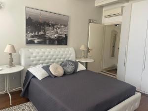 a bedroom with a large bed with pillows on it at La Suite di Giulia in Ferrara