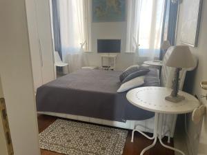 a bedroom with a bed and a table with a lamp at La Suite di Giulia in Ferrara