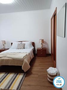 a bedroom with a bed and two night stands at Alves Nature Rooms in Arrifes