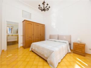Schlafzimmer mit einem Bett und Holzboden in der Unterkunft Rosa House - Breathtaking View of the Amalfi Coast in Positano