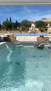 a swimming pool with blue water in a resort at Agroturisme Son Cardaix in Artá