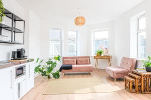 a living room with a couch and a chair at Neighbourhood Bedrooms in Cardiff