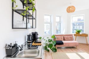 a living room with a couch and a sink at Neighbourhood Bedrooms in Cardiff
