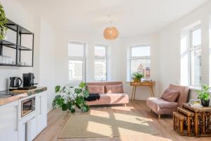 a living room with a couch and a table at Neighbourhood Bedrooms in Cardiff