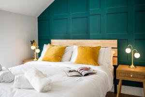 a bedroom with two beds and a green wall at Neighbourhood Bedrooms in Cardiff