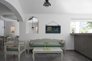 a living room with a couch and a table at Hippocampus Hotel in Kamari
