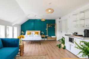 a bedroom with a bed with a green accent wall at Neighbourhood Bedrooms in Cardiff