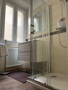 a bathroom with a shower with a glass shower stall at Casa Dilma in Lenno