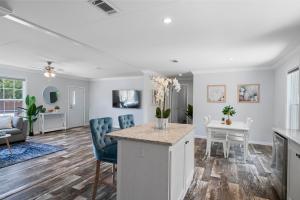 a kitchen and living room with a table and chairs at 3 King Bedrooms - Beautiful New Port Richey in New Port Richey