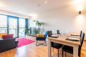 a dining room with a table and chairs and a living room at Sheffield City Centre Apartment & Balcony in Sheffield