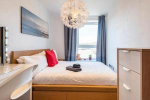 a bedroom with a bed with a chandelier at Sheffield City Centre Apartment & Balcony in Sheffield