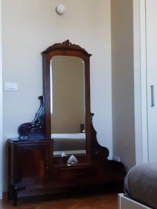マテーラにあるCasa 900の寝室のドレッサーに掛けられた木製鏡