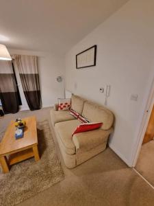 a living room with a couch and a table at Laura's Place in Isleworth