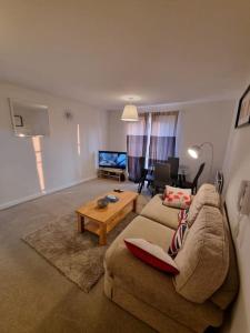 a living room with a couch and a table at Laura's Place in Isleworth