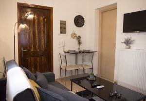 a living room with a couch and a table at Helia Apartment 1 in Alepou