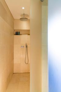 a bathroom with a shower with a shower head at La Queurie in La Courbe