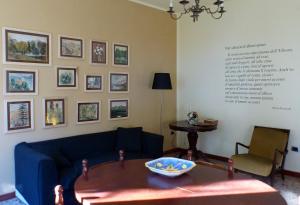 a living room with a blue couch and a table at La Villetta in Grottammare