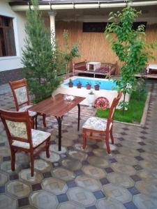 a patio with a table and chairs and a pool at SAMARKAND AMIRA in Samarkand