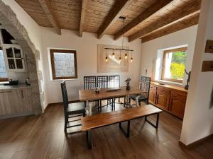 a dining room with a wooden table and chairs at Refugio del nogal - Cercedilla in Cercedilla