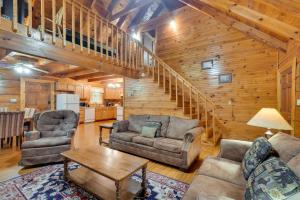 a living room with two couches and a table at Cabin with Hot Tub about 6 Mi to Downtown Gatlinburg! in Gatlinburg