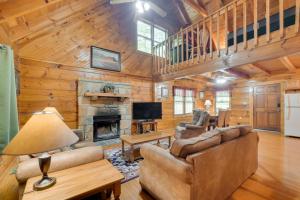 a living room with a couch and a fireplace at Cabin with Hot Tub about 6 Mi to Downtown Gatlinburg! in Gatlinburg