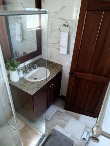 a bathroom with a sink and a glass shower at Apartamento Vista azul rodadero Laureles 801 in Rodadero