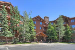 a large building with trees in front of it at Mountain Thunder Lodge in Breckenridge