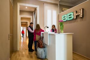 a group of people standing at a reception desk at Born Barcelona Hostel in Barcelona