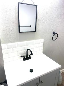 a bathroom with a white sink and a mirror at Three Zzz’s in Houston