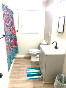 a bathroom with a toilet and a sink and a shower at Three Zzz’s in Houston