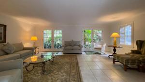 a living room with a couch and a table at PELICAN HOUSE home in Jekyll Island