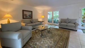 a living room with two couches and a coffee table at PELICAN HOUSE home in Jekyll Island