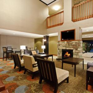 a lobby with a living room with a fireplace at Staybridge Suites Fairfield Napa Valley Area, an IHG Hotel in Fairfield