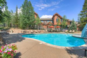 a swimming pool in front of a house at Mountain Thunder Lodge, A Vail Resorts Property in Breckenridge