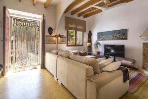 a living room with a large couch and a television at Ca Na Mon in Ses Salines