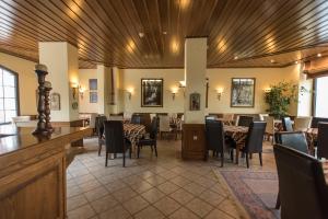 a restaurant with a dining room with tables and chairs at Anesis Hotel in Karpenisi