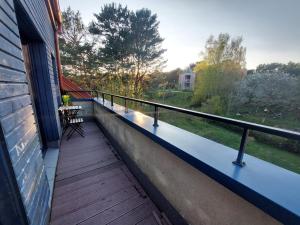 a balcony with a bench on a house at Lighthouse apartment in Nida